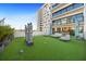 Expansive rooftop terrace featuring artificial turf, lounge seating, and modern sculptures with views of the building at 199 Dali Blvd # 407, St Petersburg, FL 33701