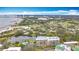 Scenic aerial view of the community showcasing the building, lake, and surrounding landscape at 220 Belleview Blvd # 101, Belleair, FL 33756