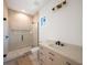 Modern bathroom featuring a walk-in shower with glass doors, elegant vanity, and contemporary fixtures at 2622 N Dundee St, Tampa, FL 33629