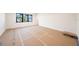 Spacious living room showcasing a large window, neutral walls, and flooring prepared for finishing touches at 2622 N Dundee St, Tampa, FL 33629