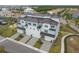 Gorgeous new construction townhomes featuring a metal roof, three-car garages, and beautifully manicured landscaping at 3027 Bermuda Sloop Cir, Ruskin, FL 33570