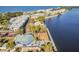 Aerial view showcasing waterfront condos, community pool, and waterfront restaurant with outdoor dining at 3027 Bermuda Sloop Cir, Ruskin, FL 33570