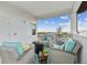 Cozy balcony with wicker furniture and views of the water and blue skies at 3027 Bermuda Sloop Cir, Ruskin, FL 33570