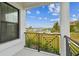 Balcony view overlooking lush landscaping, a picturesque marina, and a bright blue sky, creating a serene outdoor retreat at 3027 Bermuda Sloop Cir, Ruskin, FL 33570