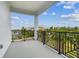 Spacious outdoor balcony featuring views of a canal and surrounding landscape with palm trees at 3027 Bermuda Sloop Cir, Ruskin, FL 33570
