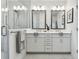 Well-lit bathroom features dual sinks, white cabinets, and a glass-enclosed shower at 3027 Bermuda Sloop Cir, Ruskin, FL 33570
