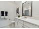 Elegant bathroom featuring a large mirror, white cabinetry, and modern fixtures at 3027 Bermuda Sloop Cir, Ruskin, FL 33570