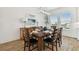 Inviting dining room with wood table, six chairs, buffet and decorative lamps under a modern chandelier at 3027 Bermuda Sloop Cir, Ruskin, FL 33570