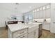 Bright kitchen with white cabinets, quartz counters, stainless appliances, and a view of the dining room at 3027 Bermuda Sloop Cir, Ruskin, FL 33570