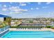 Relaxing pool area with lounge chairs overlooking the marina and boats on a sunny day at 3027 Bermuda Sloop Cir, Ruskin, FL 33570