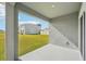 Back porch overlooking a large, green backyard with a neighboring house at 31814 Oyster Trellis Ln, Wesley Chapel, FL 33545