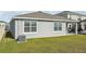 Backyard with grass, exterior windows, and a back porch at 31814 Oyster Trellis Ln, Wesley Chapel, FL 33545