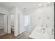 Bathroom with double vanity, large mirror, and neutral color scheme at 31814 Oyster Trellis Ln, Wesley Chapel, FL 33545