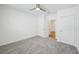 Bright bedroom with gray carpet, ceiling fan, and white doors and trim at 31814 Oyster Trellis Ln, Wesley Chapel, FL 33545