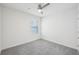 Carpeted bedroom with ceiling fan and window offering natural light at 31814 Oyster Trellis Ln, Wesley Chapel, FL 33545