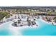 Aerial view of the community's resort-style pool area with sandy beach and palm trees at 31814 Oyster Trellis Ln, Wesley Chapel, FL 33545