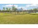 Fenced dog park with a covered seating area, providing a safe and enjoyable space for pets and their owners at 31814 Oyster Trellis Ln, Wesley Chapel, FL 33545