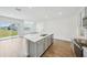 Open-concept kitchen features a large island with sink, stainless steel appliances, and seamless flow to the living area at 31814 Oyster Trellis Ln, Wesley Chapel, FL 33545