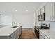 This modern kitchen offers stainless steel appliances, white countertops and gray cabinets, perfect for cooking at 31814 Oyster Trellis Ln, Wesley Chapel, FL 33545