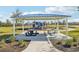 Community picnic area with covered seating, picnic tables, playground and ample green space at 31814 Oyster Trellis Ln, Wesley Chapel, FL 33545