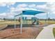 Community playground featuring a shaded play structure with slides and swings at 31814 Oyster Trellis Ln, Wesley Chapel, FL 33545