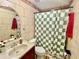 Well-maintained bathroom featuring stone-look tile, a vanity with storage, and a shower/tub combination at 37634 Hidden Park Ct, Dade City, FL 33525