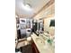 Functional bathroom with wood-look tile, shower/tub combo with modern fixtures, and a vanity with storage at 37634 Hidden Park Ct, Dade City, FL 33525
