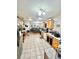 View of kitchen with light wood cabinets and tile floor extending to dining room in an open concept floor plan at 37634 Hidden Park Ct, Dade City, FL 33525