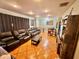 Cozy living room featuring plush leather seating, recessed lighting, and warm, inviting decor at 37634 Hidden Park Ct, Dade City, FL 33525