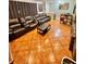 Comfortable living room offering a leather sofa set and unique tile flooring at 37634 Hidden Park Ct, Dade City, FL 33525