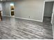 Bright living room featuring laminate flooring and neutral paint, creating a welcoming atmosphere at 37634 Hidden Park Ct, Dade City, FL 33525