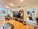 Well-lit living room showcasing a large TV and decorative shelving, enhancing the entertainment space at 37634 Hidden Park Ct, Dade City, FL 33525