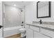 Tastefully designed bathroom with sleek vanity, tub with tile surround, and black hardware at 4621 Kenoska St, North Port, FL 34288