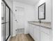 Modern bathroom with sleek granite countertop, and a glass-enclosed shower at 4621 Kenoska St, North Port, FL 34288