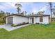 This charming home features a well-maintained lawn and thoughtful landscaping at 4621 Kenoska St, North Port, FL 34288