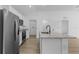 The modern kitchen features stainless steel appliances, granite countertops, and an open layout at 4621 Kenoska St, North Port, FL 34288
