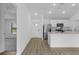 Open-concept kitchen featuring stainless steel appliances, granite countertops, and modern fixtures at 4621 Kenoska St, North Port, FL 34288