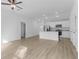 Open-concept living area with modern flooring, recessed lighting, and kitchen access at 4621 Kenoska St, North Port, FL 34288