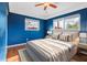 Comfortable bedroom with hardwood floors, ceiling fan, and plenty of natural light at 5166 39Th S St, St Petersburg, FL 33711