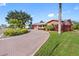 Charming home featuring a brick driveway, lush landscaping, and a well-maintained lawn at 5166 39Th S St, St Petersburg, FL 33711
