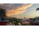 Charming home with lush landscaping and solar panels under a colorful sunset sky at 5166 39Th S St, St Petersburg, FL 33711