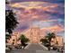 Stunning exterior of a grand pink hotel with palm trees set against a vibrant, colorful sunset sky at 5166 39Th S St, St Petersburg, FL 33711