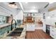 Open kitchen overlooking the dining and living area featuring stainless appliances and stone counters at 5166 39Th S St, St Petersburg, FL 33711