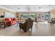 Bright and spacious living room featuring a large window, tile flooring, and comfortable seating at 5166 39Th S St, St Petersburg, FL 33711