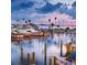 Picturesque marina with various boats docked, reflecting a colorful sunset on the calm water at 5166 39Th S St, St Petersburg, FL 33711
