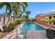Beautiful outdoor pool area surrounded by a lush tropical garden and a private fence at 5166 39Th S St, St Petersburg, FL 33711