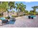 Refreshing pool area with brick patio, palm trees, lounge seating, and a well-maintained backyard at 5166 39Th S St, St Petersburg, FL 33711