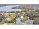 Aerial view of the property showcasing its proximity to a serene lake and lush green landscape at 15005 Lake Emerald Blvd, Tampa, FL 33618