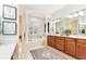 Large bathroom boasts a double vanity, soaking tub, and separate shower, all with elegant columns at 15005 Lake Emerald Blvd, Tampa, FL 33618