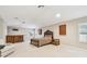 Expansive bonus room with bar, comfortable seating, and natural light at 15005 Lake Emerald Blvd, Tampa, FL 33618